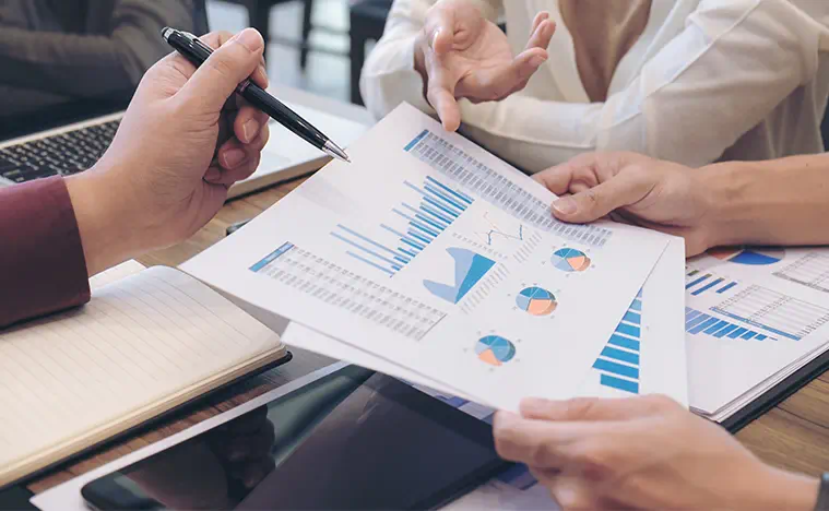 Property Management Services Month End Financial Reports Two people going over financial reports.