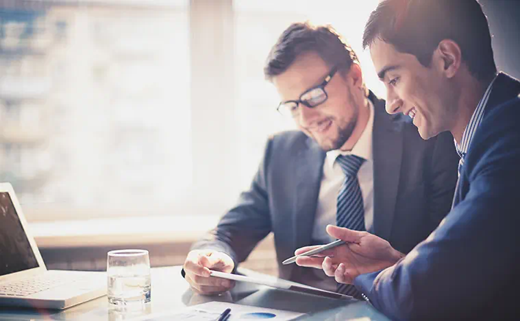 Property Management Services Property Inspection Two business people looking over reports.