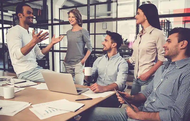 Setting the Standards A discussion of business people take place in an informal meeting room.