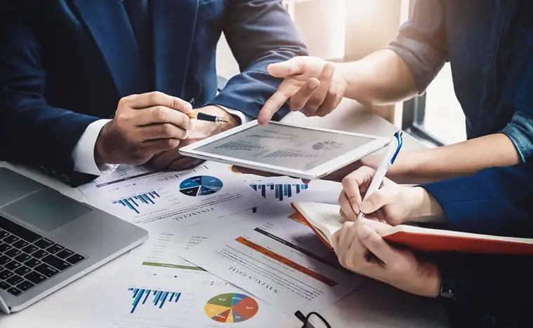 Several business people look over reports.